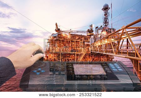 Double Exposure Of Hand Control Automate Contol Panel With Oil And Gas Industry Background  For Indu