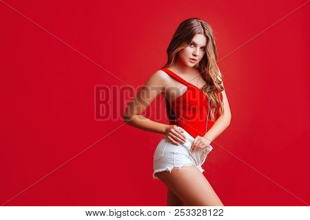 Pretty Bikini Model In Studio On Red Background
