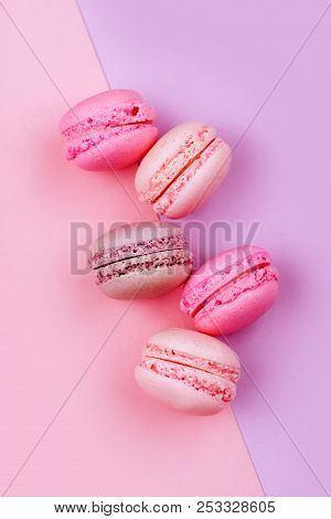 Group Of Sweet Pink And White Mini Macarons On Soft Pink Paper Background With Copy Space For Adding