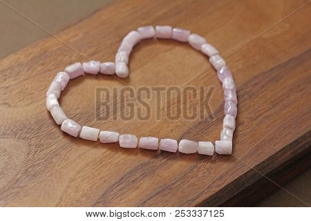 Pink Heart On A Wooden Background. Kunzite Is A Natural Pink Stone For Creating Jewelry. Natural Cry