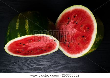 One Watermelon Cut In Halves Isolated On Black Background With Clipping Path