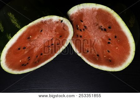 One Watermelon Cut In Halves Isolated On Black Background With Clipping Path