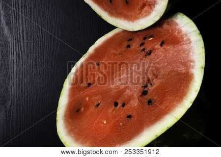 One Watermelon Cut In Halves Isolated On Black Background With Clipping Path