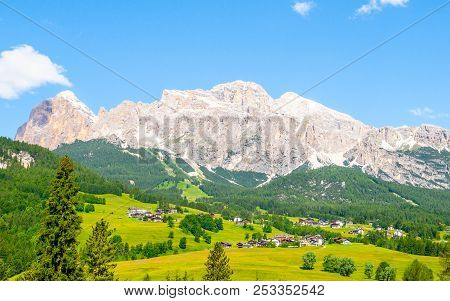 Landscape Of Dolomites With Green Meadows, Blue Sky, White Clouds And Rocky Mountains