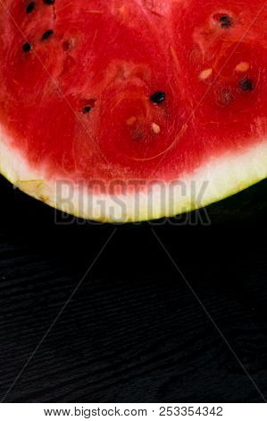 A Half Of Fresh Watermelon Isolated On Black Background.