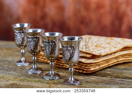 Matzot And Red Wine Four Glasses Of Symbols Of Passover
