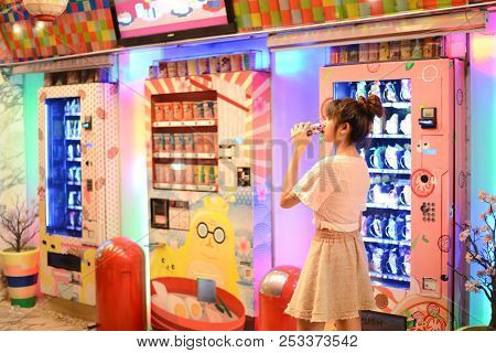 Roiet, Thailand - 26 Dec, 2016 :  An Unidentifed Woman Posting In Front Of Colorful Japanese Vending