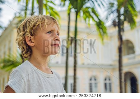 Boy On Background Of Old Town Hall In George Town In Penang, Malaysia. The Foundation Stone Was Laid