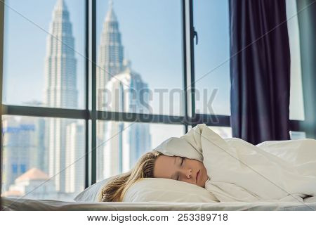 Woman Wakes Up In The Morning In An Apartment In The Downtown Area With A View Of The Skyscrapers. L