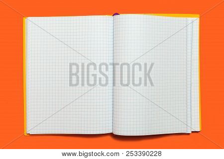 White Opened Workbook Lying On An Orange Background. Concept Of Business Or Educational Equipment. F