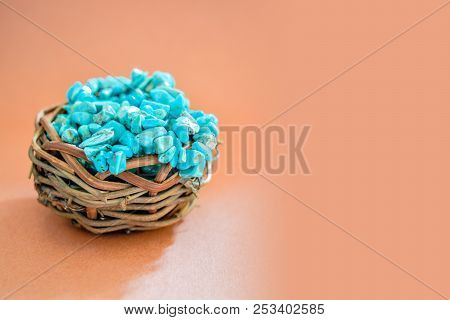 Pile Stones Of Raw Turquoise In Small Wooden Nest On A Brown Background. Blue And Green Color Stones