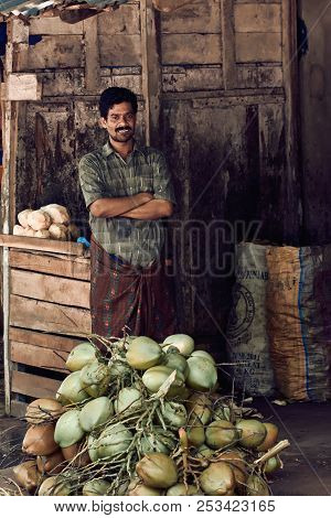 Varkala, Kerala, India - November 30, 2017: Portrait Of Unidentified Indian Man Wiht Coconats. Daily