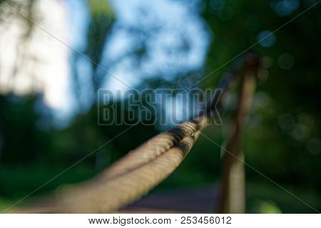 Thick Steel Rope Close Up. Bridge Fence Element. Detailed View. The Surface Of The Steel Cable Is Co