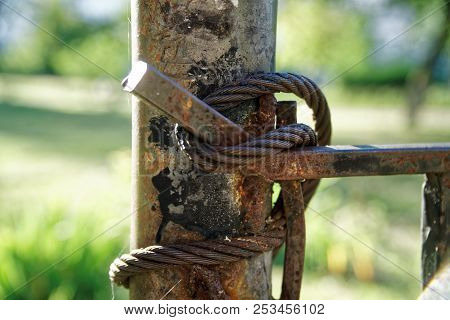 Thick Steel Rope Close Up. Bridge Fence Element. Detailed View. The Surface Of The Steel Cable Is Co