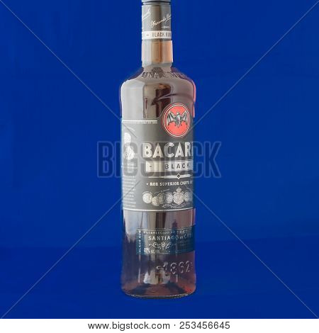 Studio Shot A Bottle Of Bacardi Black Rum Isolated On Blue Background