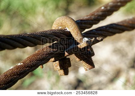 Thick Steel Rope Close Up. Bridge Fence Element. Detailed View. The Surface Of The Steel Cable Is Co