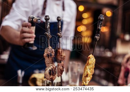 Meat On Skewer Fry With A Cooking Gas Torch Flomber. Preparation Of Delicious Fresh Meat Frying With