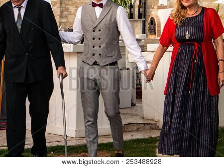 Father And Mother Accompany His Son To The Wedding Ceremony
