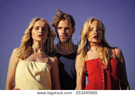 Twins Women With Macho On Blue Sky Background. Love Triangle And Romance. Beauty And Summer Fashion.