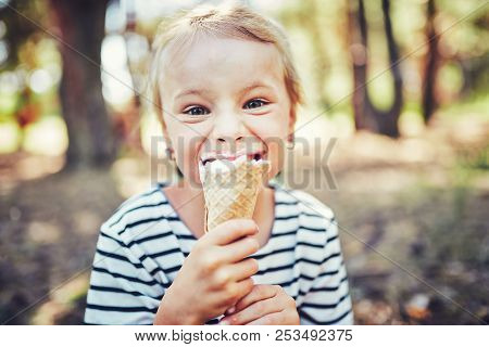 Kid Eating Ice Cream. Funy Child With Icecream Outdoor.
