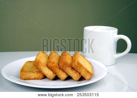 Sweet And Crunchy Rusk Or Toast In A Plate With Coffee Mug And Space For Copy