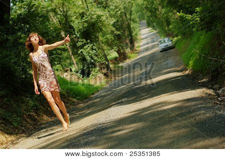 Pretty girl hitching hiking.