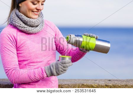Woman Athlete Fit Girl Wearing Warm Sporty Clothes Outdoor In Cold Weather Drinking Hot Tea From Vac