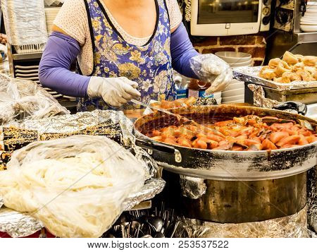 Seoul, South Korea - June 21, 2017: Woman Vendor Serving Customers At Gwangjang Market In Seoul.