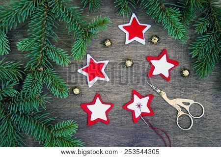 Christmas Party Preparation Background With Sewing Star Figures From Red Anf White Felt, Needle With