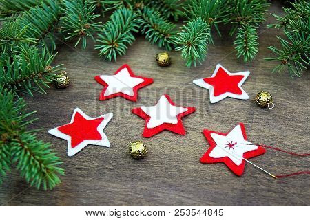 Christmas Party Preparation Background With Sewing Star Figures From Red Anf White Felt, Needle With