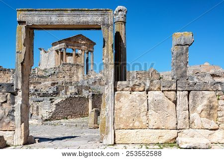 Ancient Temple Framed By A Door In The Historic Roman Ruins Of Dougga In Tunisia