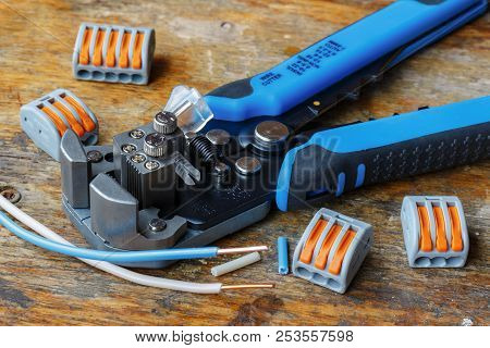 Copper Wires With Wire Stripper And Quick-release Wire Terminal On Wooden Table In Workshop
