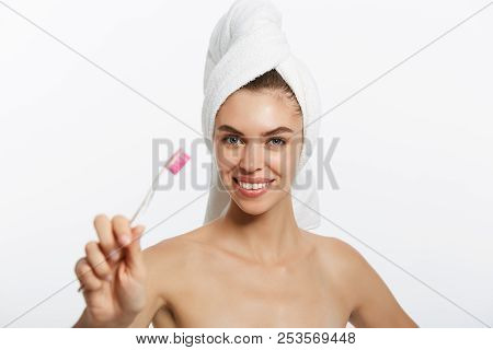 Smiling Woman Brushing Her Teeth With Towel On Her Head. A Great Smile