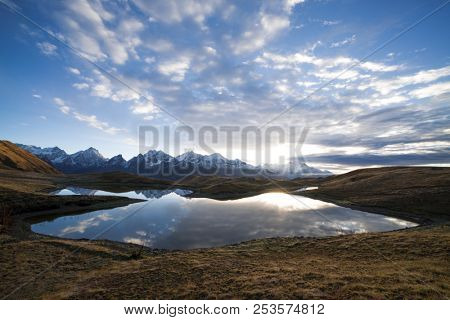Beautiful mountain lake. Reflection of sky in water. Lake Koruldi. Caucasus, Georgia, Zemo Svaneti