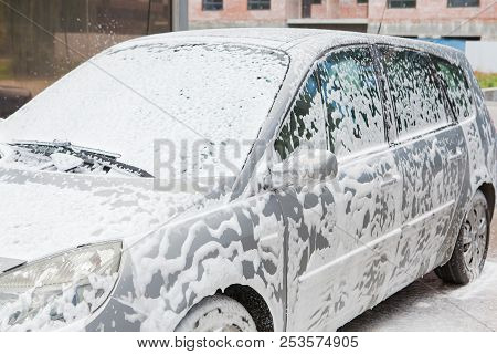 Car Wash With Foam In Car Wash Station. Carwash. Washing Machine At The Station. Car Washing Concept