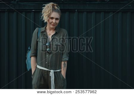 Urban People Concept. Carefree Young Woman Portrait Smiling, Dressed In A Khaki Romper With A Backpa