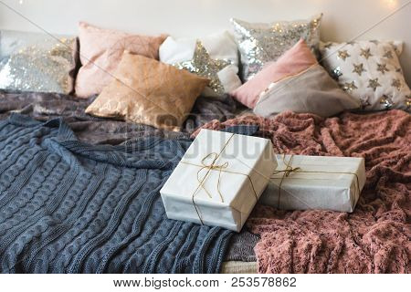 Xmas In Morning Bedroom. Double Bed In Christmas Interior On White Wall Background With Cozy Lights.