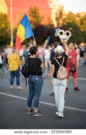 Romania, Bucharest - August 11, 2018: Protester Girls Displaying Centenary Icon As Handcuffs