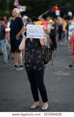 Romania, Bucharest - August 12, 2018: Protester Holding Sign While Talking On The Phone
