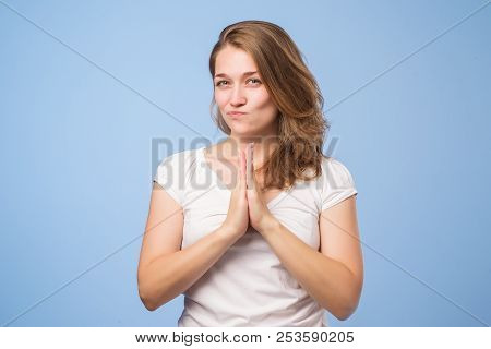 Headshot Of Cunning Beautiful Woman In White Tshirt Looking Aside Holding Hand Under Chin. She Has A