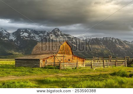 The Moulton Barn In The Warm Morning Light With Storm Clouds Over The Grand Teton Mountain Range In 