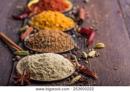 Heaps Of Various Ground Spices On Wooden Background. Georgian Spices, Indian Spices, Arabian Spices.