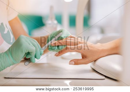 Professional Nail Master Using File While Polishing Nails