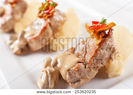 Pork Medallions With Mashed Potato And Mushrooms. Pork Tenderloin On A White Plate, Good Serving. Re