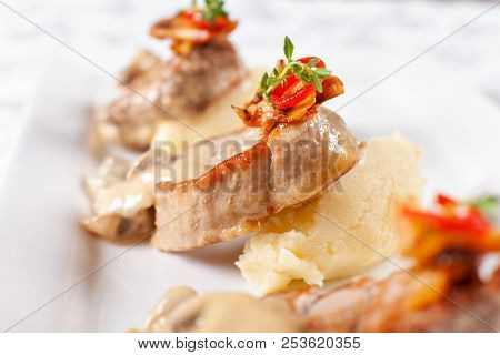 Pork Medallions With Mashed Potato And Mushrooms. Pork Tenderloin On A White Plate, Good Serving. Re