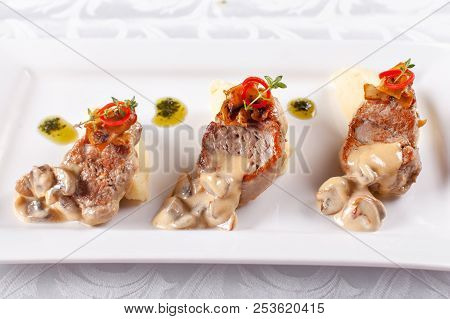 Pork Medallions With Mashed Potato And Mushrooms. Pork Tenderloin On A White Plate, Good Serving. Re