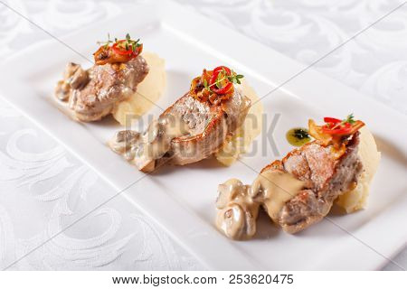Pork Medallions With Mashed Potato And Mushrooms. Pork Tenderloin On A White Plate, Good Serving. Re