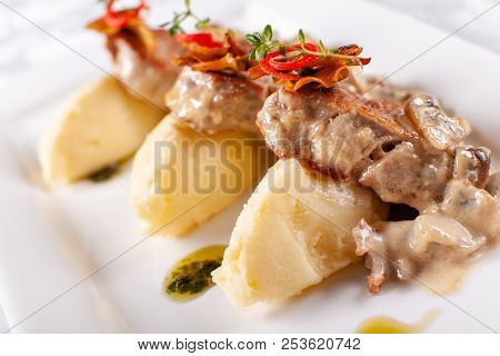 Pork Medallions With Mashed Potato And Mushrooms. Pork Tenderloin On A White Plate, Good Serving. Re