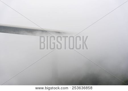 Misty Landscape With The Tallest Viaduct In Germany, The Kochertalbrucke, Crossing Over Wooded Hills
