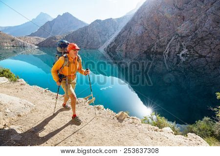 Wanderlust time. Man hiking in beautiful Fann mountains in Pamir, Tajikistan. Central Asia.